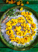 Dandelion flowers and buds on a plate