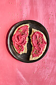 Pita bread with beetroot spread and sesame seeds
