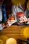 Two people toast each other in a stylish atmosphere