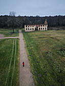 Aerial view of the historic republic of Paulava ruins surrounded by tranquil greenery and a winding path,Merkine,Lithuania