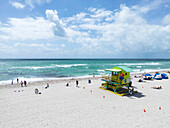 Aerial view of a beautiful beach with a lifeguard house and people enjoying the sun,Miami Beach,United States
