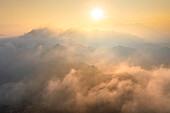 Aerial view of Jinshanling Great Wall amidst misty mountains at sunset,Luanping County,China