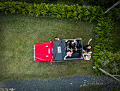 Salento,Colombia - 13 February 2024: Aerial view of people and red jeep in lush greenery,Salento,Colombia