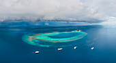 Panoramic aerial view of luxury yachts docked along the Atoll on Maldives archipelagos