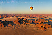 Aerial view of hot air balloon flying over Namibia desert
