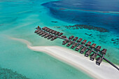 Aerial view of bungalows of a luxury resort along Moofushi Reef,Alif Alif Atoll,Maldives archipelagos