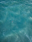 Aerial view of a serene surfer swimming in the beautiful Atlantic Ocean,Atlantic Beach,United States