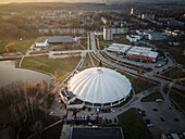 Aerial view of indoor snowcenter Elektrenu ledo arena surrounded by urban landscape and greenery,Elektrenai,Lithuania
