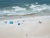Aerial view of a beautiful beach with waves and people enjoying the sunny day,Tybee Island,United States