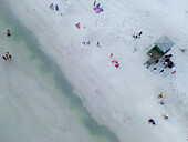 Aerial view of colorful lifeguard house on sandy beach with people enjoying the sunny day,Siesta Key,United States