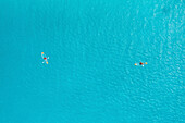 Aerial Top Down View Of Two People Kayaking Over Clear Blue Ocean Water In Male,Maldives