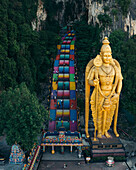 Aerial view of the colorful Batu Caves with the towering statue of Murugan and historic temple steps,Batu Caves,Malaysia