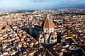 Aerial view of the beautiful Santa Maria del Fiore cathedral amidst the iconic cityscape and colourful rooftops,Florence,Italy