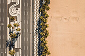 Aerial Top Down View Of Palm Trees On Empty Copacabana Beach,Alongside Famous Mosaic Sidewalk And Avenida Atlantica Road,During Coronavirus Lockdown In Rio De Janeiro,Brazil