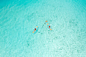 Aerial Top Down View Of Two People Kayaking in Clear Blue Ocean Water In Male,Maldives