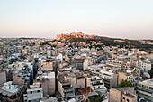 Aerial view of the iconic Acropolis amidst a beautiful cityscape at sunset,Athens,Greece