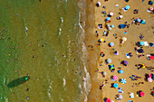 Aerial view of a beautiful sandy beach with umbrellas and people enjoying the summer by the Black Sea,Sariyer,Turkey