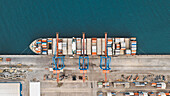 Aerial view of beatifully abstract container ship being loaded at Malaga Port,Spain