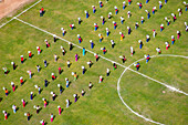 Aerial view of a vibrant community sports event with people engaging in outdoor activities on a lush green field,Side,Turkey