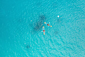 Aerial Top Down View Of Two People Kayaking Past Buoy Over Clear Blue Ocean Water In Male,Maldives