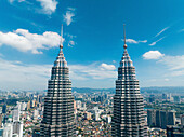 Aerial view of the iconic petronas towers amidst a modern skyline with bustling urban landscape,kuala lumpur,malaysia