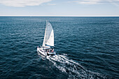 Luftaufnahme eines Katamaran-Segelboots auf dem offenen Pazifik vor der Küste von Sydney, Australien