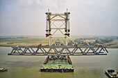 Aerial view of a building site while assembling the Padma bridge,the longest rail and highway bridge in Bangladesh crossing the Padma river,Zajira,Dhaka,Bangladesh