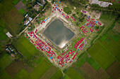 Aerial view of people working in fields drying red chilies at Mirzapur,Panchagarh,Bangladesh