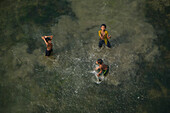 Dhaka,Bangladesh - 23 January 2017: Aerial view of kids playing in a lagoon in countryside near Dhaka,Bangladesh