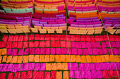 Aerial view of a man working in a public laundry stretching colourful cloth along Brahmaputra river in Araihazar,Dhaka,Bangladesh