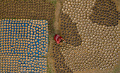 Aerial view of a woman patiently hand working with clay pots in Rajshahi state,Bangladesh