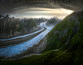 Aerial view of Glacier with dramatic sky and snow-covered mountains,Alaska,United States