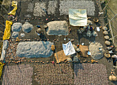 Aerial view of people working in a fish market drying fish at Lalpur Launch Ghat along Meghna River,Chattogram,Bangladesh