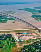 Aerial view of Padma bridge,over the padma river by day in lateral perspective,Shibchar,Dhaka,Bangladesh