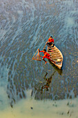 Badalgachhi,Bangladesh - 30 January 2021: Aerial view of fishermen on a canoe sailing the Jamuna river,Bangladesh