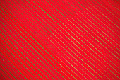 Aerial view of agricultural fields used for drying hundreds of meters of red cotton fabric roll near Narsingdi,township,Dhaka,Bangladesh