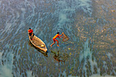 Badalgachhi,Bangladesh - 30 January 2021: Aerial view of fishermen on a canoe sailing the Jamuna river,Bangladesh