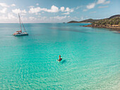 Aerial view of a woman on a stand up paddle board at South Whitehaven Beach,Queensland,Australia