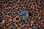Sahajanpur,Bangladesh - 19 December 2021: Aerial view of a person working with clay pots in a factory,Bangladesh