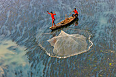 Badalgachhi,Bangladesh - 30 January 2021: Aerial view of fishermen on a canoe sailing the Jamuna river,Bangladesh
