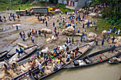 Dhaka,Bangladesh - 04 August 2021: Aerial view of people trading and sailing using long fishing canoes along Kaliganga river,Ghior,Dhaka province,Bangladesh