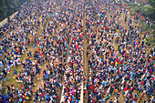 Gazipur,Bangladesh - 12 January 2020: Aerial view of a large congregation of people for a muslim festival on the top of trains at train station in Dhaka,Bangladesh