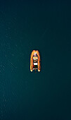 Aerial view of an orange inflatable boat moored in the Ionian Sea,Calabria,Italy
