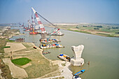 Aerial view of a building site while assembling the Padma bridge,the longest rail and highway bridge in Bangladesh crossing the Padma river,Zajira,Dhaka,Bangladesh