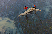 Badalgachhi,Bangladesh - 30 January 2021: Aerial view of fishermen on a canoe sailing the Jamuna river,Bangladesh