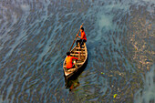 Badalgachhi,Bangladesh - 30 January 2021: Aerial view of fishermen on a canoe sailing the Jamuna river,Bangladesh