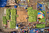 Dhaka,Bangladesh - 11 April 2019: Aerial view of several small commercial boats with people unloading watermelons at Old Dhaka river port along Buriganga river in Dhaka,Bangladesh