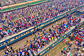 Gazipur,Bangladesh - 12 January 2020: Aerial view of a large congregation of people for a muslim festival on the top of trains at train station in Dhaka,Bangladesh