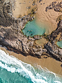 Aerial view of two people floating in the Champagne Pools,Fraser Island,Australia. Top down perspective