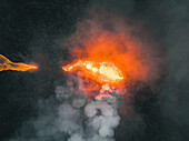 Aerial view of a lava explosion and the fog in Iceland